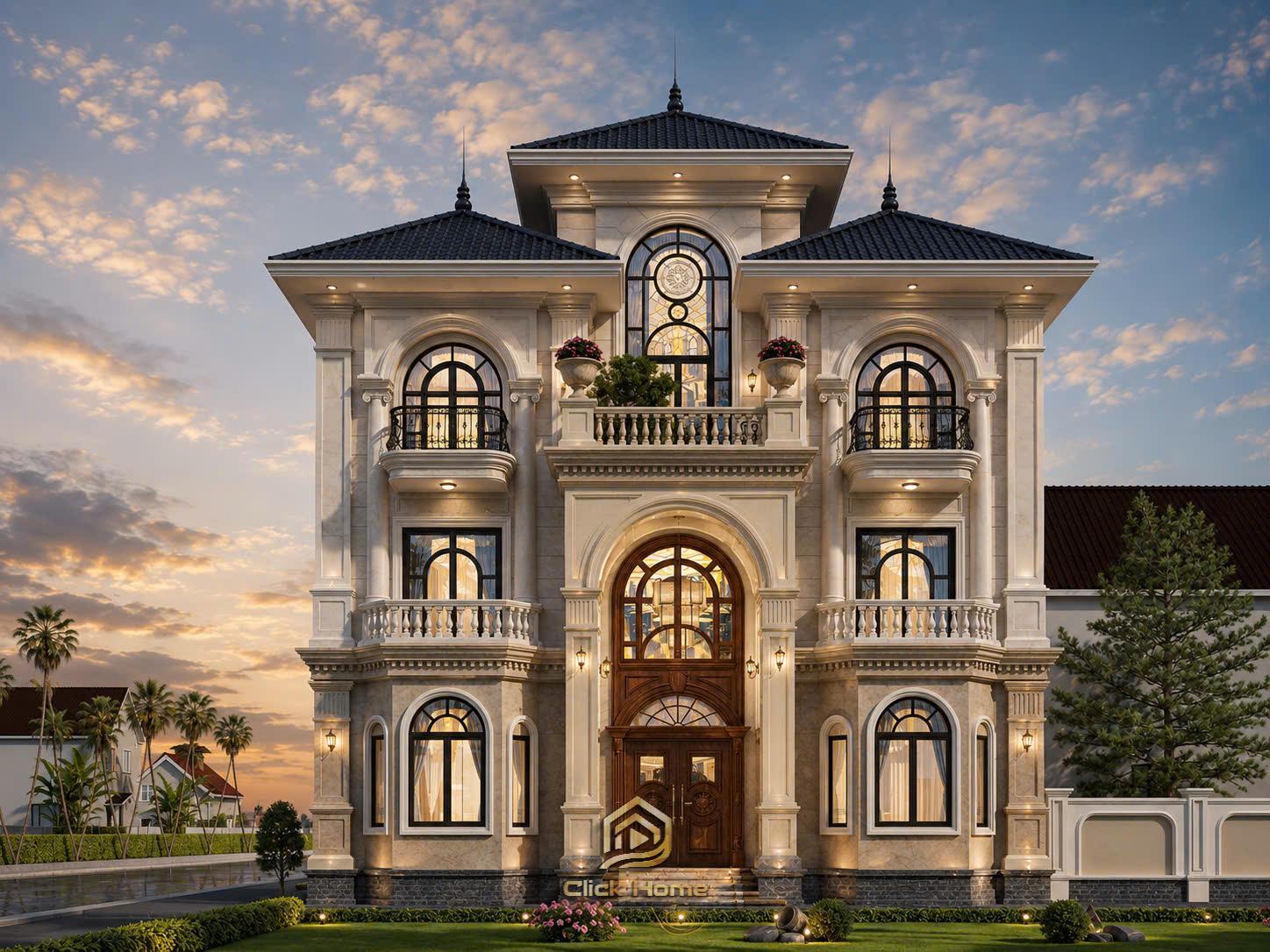 Mặt tiền biệt thự lung linh khi lên đèn lúc chiều tà. Hệ thống đèn ngoại thất màu vàng ấm làm nổi bật tone sơn trắng kem hoàng gia và khối kiến trúc đăng đối, đẳng cấp.