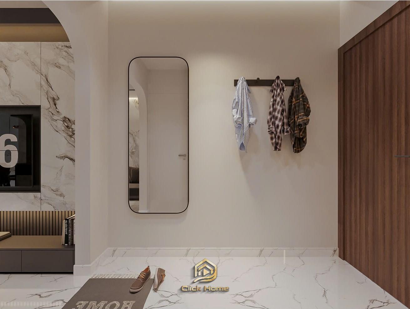 Hành lang lối vào căn hộ hiện đại trang bị gương đứng, móc treo đồ và đèn led âm trần ấm cúng.