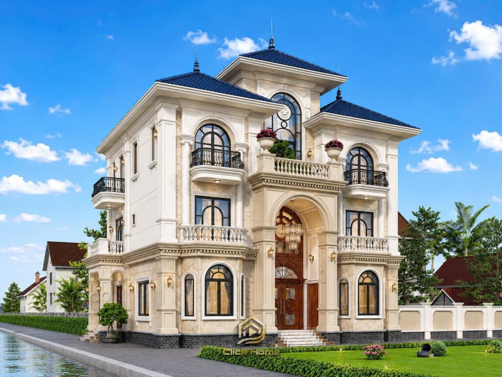 Góc nhìn nghiêng bên phải mẫu nhà tân cổ điển 3 tầng mái Nhật bề thế dưới ánh sáng buổi sáng. Đường nét kiến trúc Pháp cổ điển được khắc họa rõ nét qua hệ cửa sổ kính lớn giúp tối ưu ánh sáng tự nhiên.